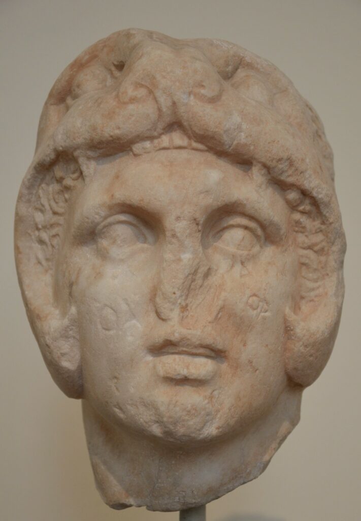 Alexander is depicted as a young man with short hair, with the face of the lion over the top of his head.