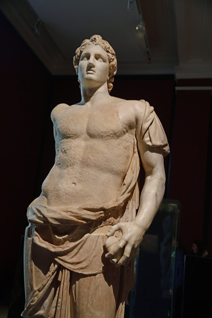 Full length statue, Alexander with naked torso, holding an object in his left hand