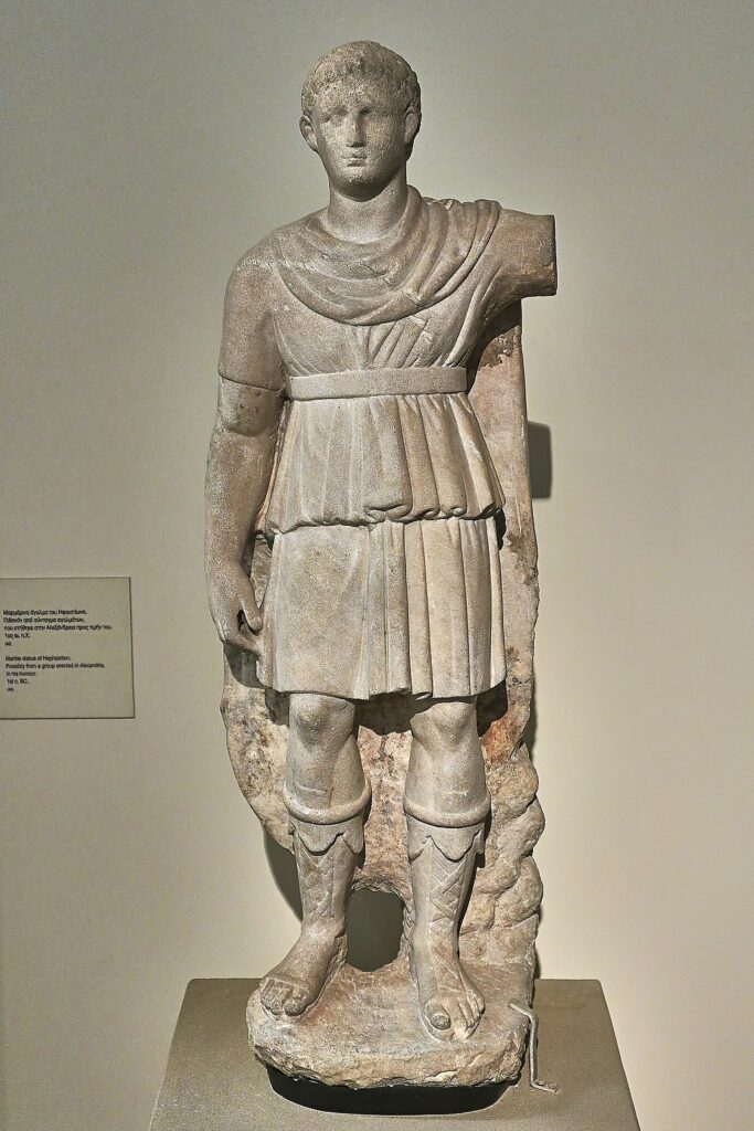 Full length statue of Alexander fully clothed with belted tunic, kilt, leg guards, and cloak