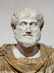 Marble bust of Aristotle, depicted as middle aged with full beard and bushy hair, wearing a mantle