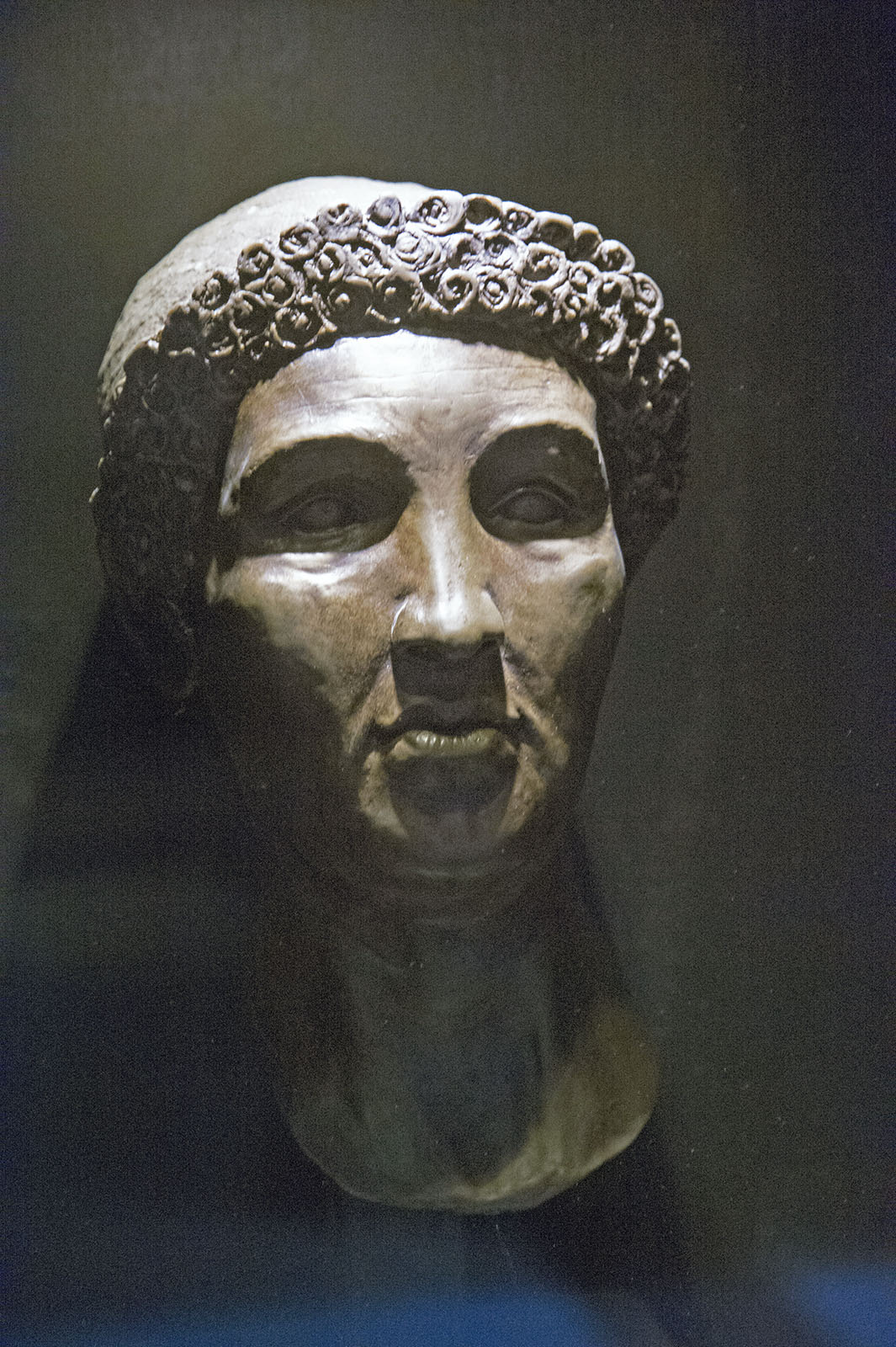 Sculptured head of a mature woman, with a strong face, and elaborate hairstyle