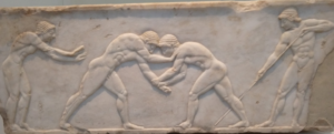 Two wrestlers in action in the Palaistra. This Pentelic marble base for a funerary kouros for an athlete dates from c. 510 BC. It was found in the Keremeikos in Athens.