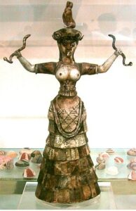 Sculpture of Snake Goddess, a cat poised on her head