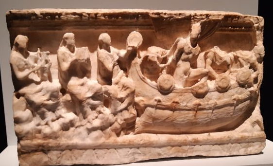 Carving on an urn depicting Odysseus tied to the mast of a ship with Sirens playing instruments